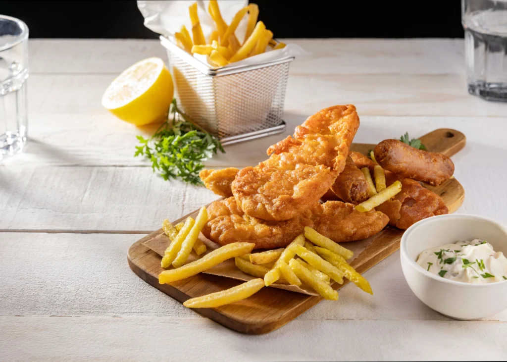 Crispy gluten-free fish fillet and fries with pro tips like sweet potato fries and seasoning options on the side.