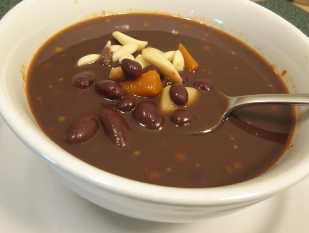 Bowl of purple black bean soup with visible black beans, spinach, and colorful vegetables, surrounded by labels showing benefits like "Protein-Packed" and "High in Fiber."