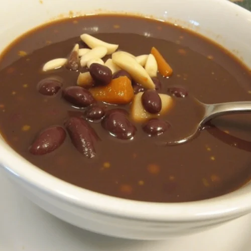 Bowl of purple black bean soup with visible black beans, spinach, and colorful vegetables, surrounded by labels showing benefits like "Protein-Packed" and "High in Fiber."